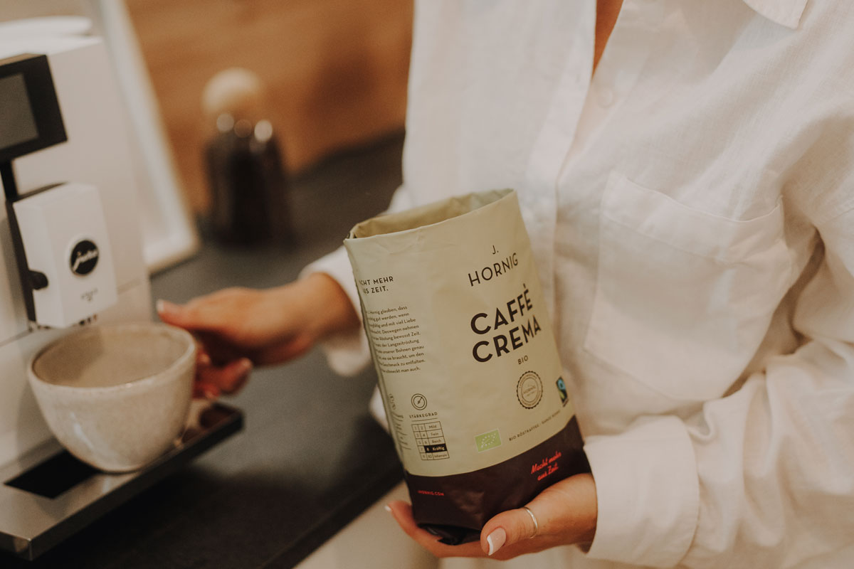 J. Hornig Caffè Crema Bio vor Vollautomat in moderner Küche